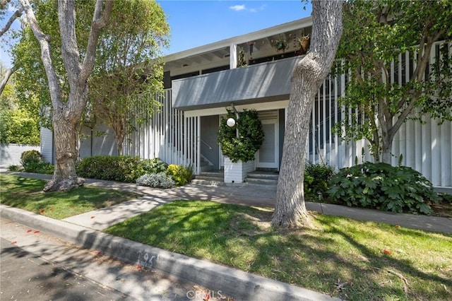 view of front of house with a front yard and entry steps