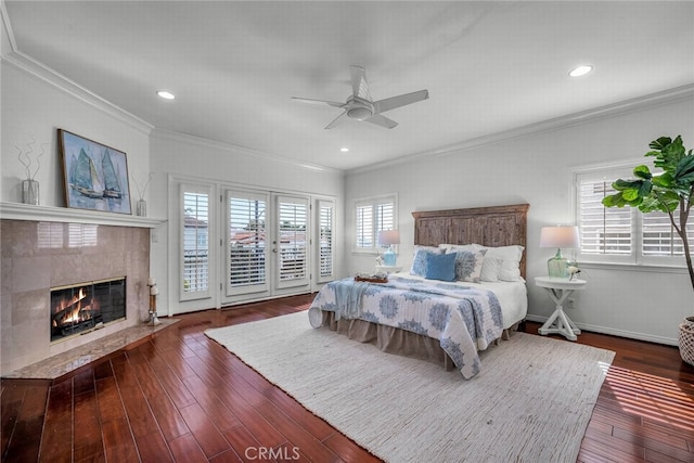 bedroom featuring a fireplace, wood-type flooring, access to outside, and crown molding
