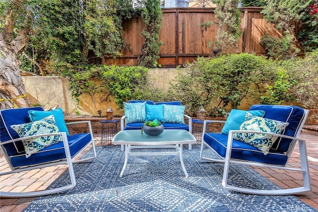 view of patio / terrace with an outdoor living space and fence