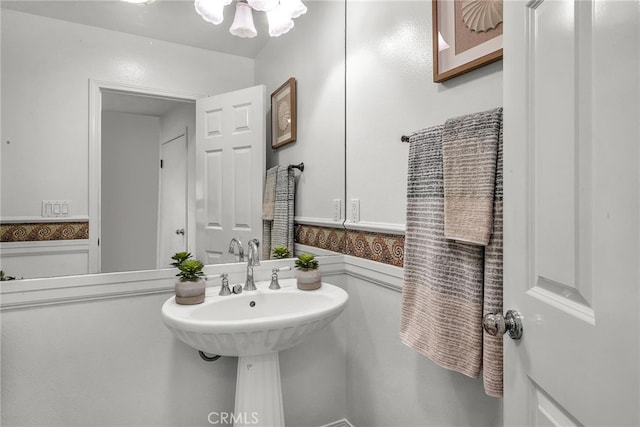 bathroom with a notable chandelier