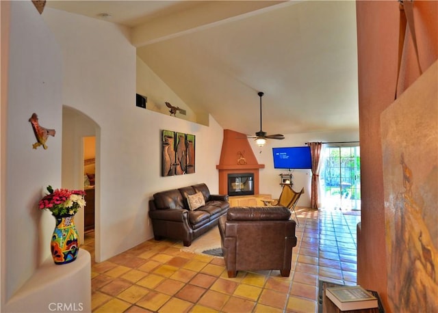 living area with ceiling fan, beamed ceiling, arched walkways, and high vaulted ceiling