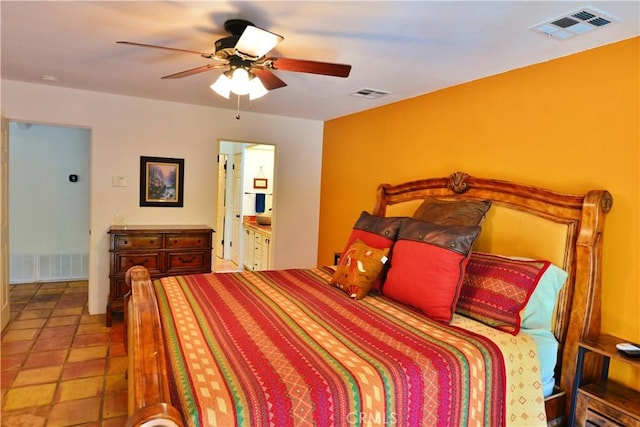 bedroom featuring ceiling fan, ensuite bath, and visible vents