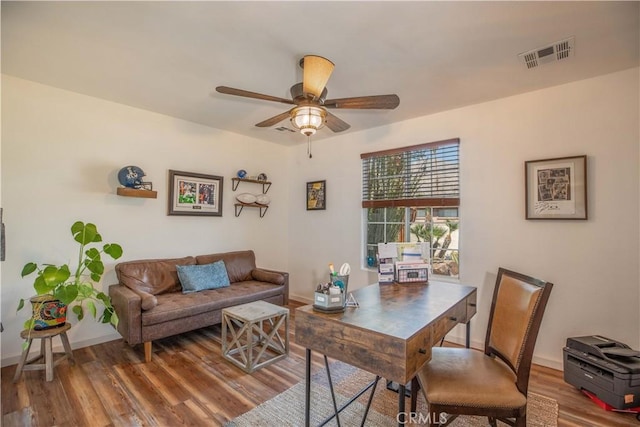 home office with ceiling fan, baseboards, visible vents, and wood finished floors