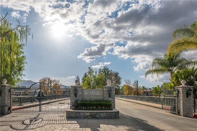 community / neighborhood sign with a gate