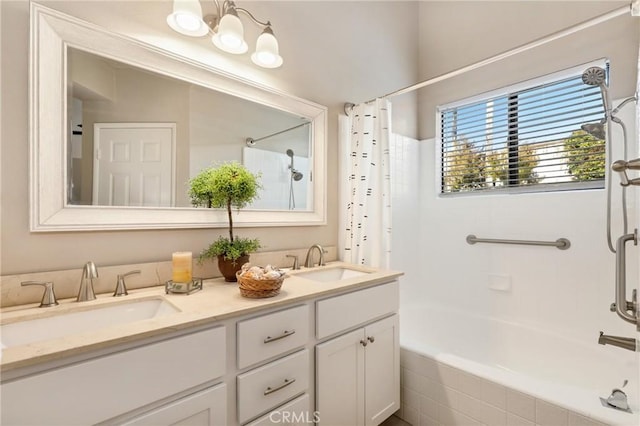 full bath featuring a sink, shower / bath combo with shower curtain, and double vanity