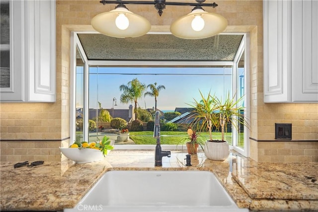 2107 Camino Laurel, San Clemente, CA 92673 - kitchen view of white cabinetry, backsplash, and light stone counters