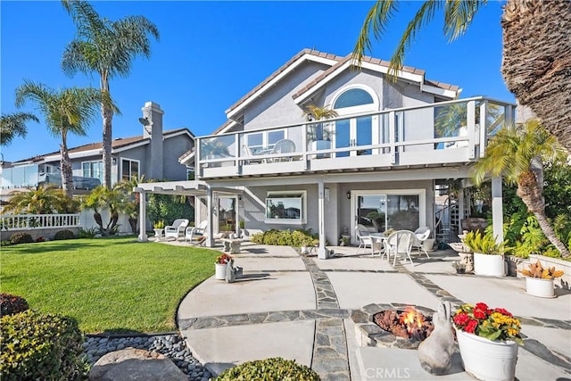 2107 Camino Laurel, San Clemente, CA 92673 - back of house featuring an outdoor fire pit, a patio area, a yard, a balcony, and a pergola