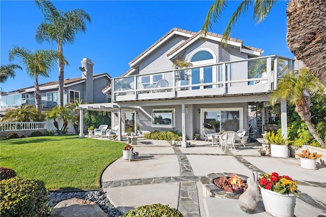 2107 Camino Laurel, San Clemente, CA 92673 - back of house with an outdoor fire pit, a patio, a lawn, a balcony, and a pergola