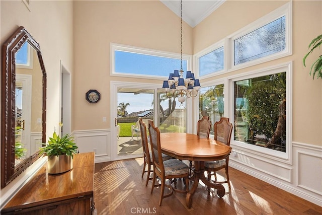 2107 Camino Laurel, San Clemente, CA 92673 - dining room featuring ornamental molding, high vaulted ceiling, wood finished floors, a chandelier, and wainscoting