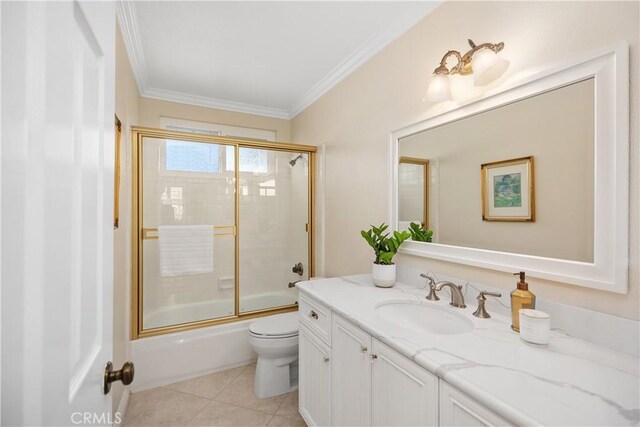 full bathroom with tile patterned floors, toilet, vanity, crown molding, and bath / shower combo with glass door