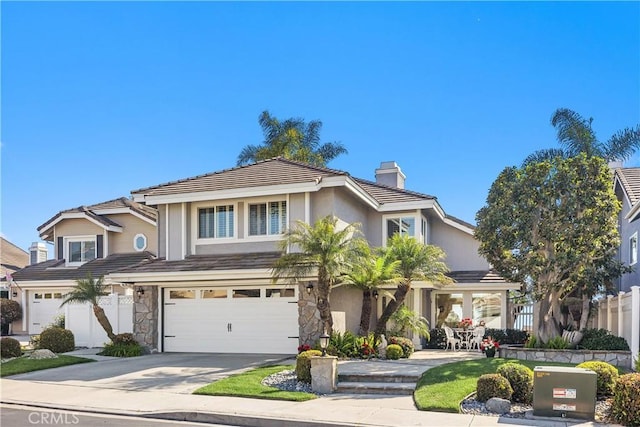2107 Camino Laurel, San Clemente, CA 92673 - traditional-style home featuring a garage, a chimney, concrete driveway, a tiled roof, and stone siding