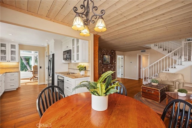 2107 Camino Laurel, San Clemente, CA 92673 - dining space featuring light wood finished floors, stairway, a chandelier, wood ceiling, and beverage cooler