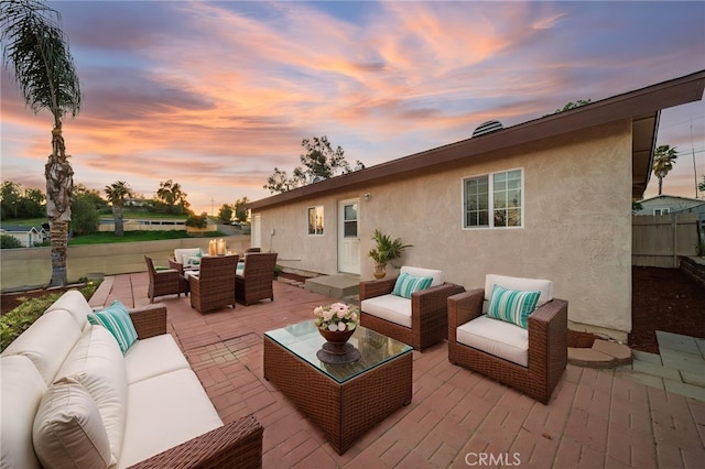 23755 Goetz Dr, Menifee, CA 92587 - deck at dusk featuring an outdoor hangout area, fence, outdoor dining area, and a patio area
