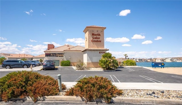 view of building exterior with uncovered parking