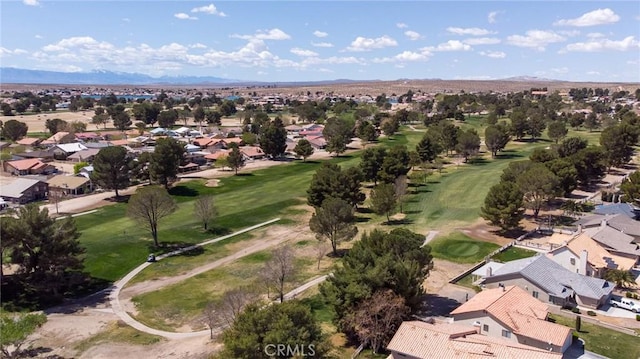 drone / aerial view with view of golf course and a residential view