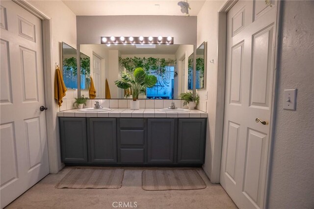 full bathroom featuring double vanity and a sink