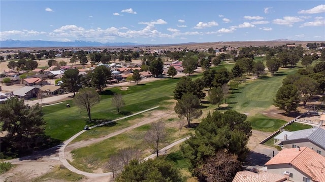 bird's eye view with view of golf course, a residential view, and a mountain view