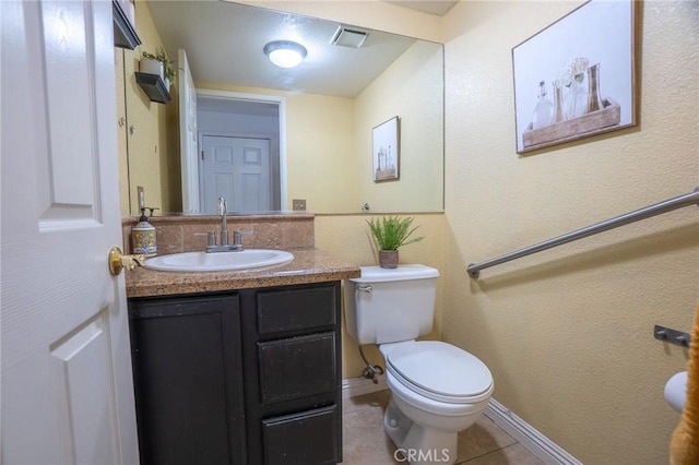 half bathroom with toilet, tile patterned flooring, baseboards, and vanity