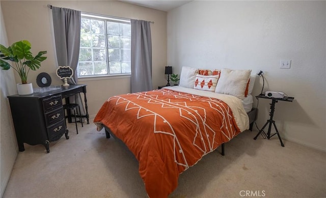 bedroom with baseboards and carpet
