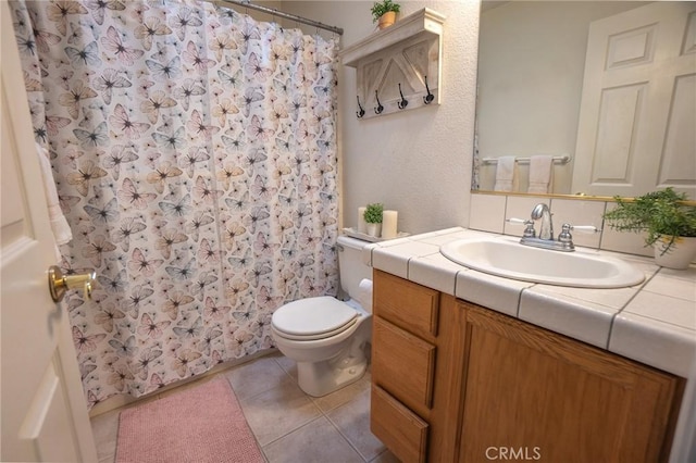 full bathroom with toilet, tile patterned floors, curtained shower, and vanity