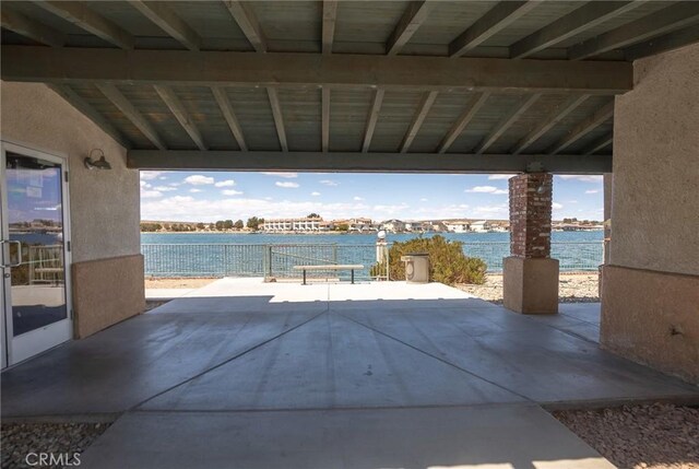 view of patio featuring a water view and outdoor dining area