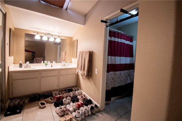 1284 William Mcgrath St, Colton, CA 92324 - full bath with tile patterned floors, double vanity, lofted ceiling, and a shower with shower curtain