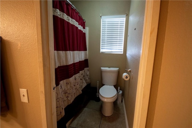1284 William Mcgrath St, Colton, CA 92324 - bathroom with tile patterned floors, toilet, and a shower with shower curtain