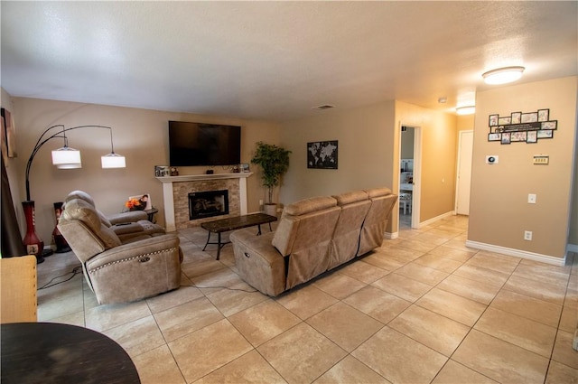 1284 William Mcgrath St, Colton, CA 92324 - living room with light tile patterned floors, a tile fireplace, and baseboards