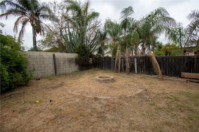 1284 William Mcgrath St, Colton, CA 92324 - fenced backyard with an outdoor fire pit