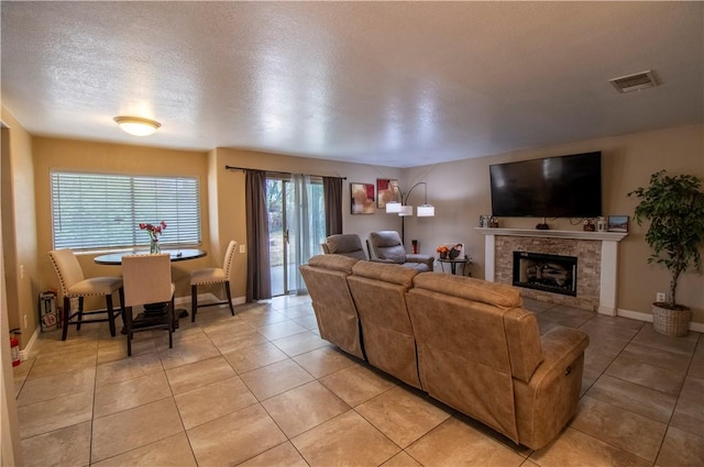 1284 William Mcgrath St, Colton, CA 92324 - living area with light tile patterned floors, a tile fireplace, a textured ceiling, and baseboards