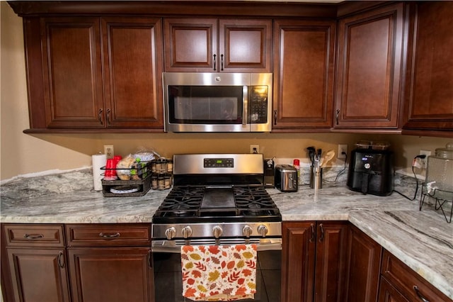 1284 William Mcgrath St, Colton, CA 92324 - kitchen with stainless steel appliances and light stone countertops