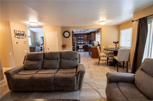 1284 William Mcgrath St, Colton, CA 92324 - living room featuring light tile patterned floors and plenty of natural light
