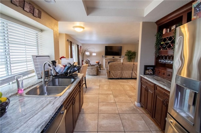 1284 William Mcgrath St, Colton, CA 92324 - kitchen featuring stainless steel appliances, a sink, light tile patterned flooring, a tray ceiling, and light countertops