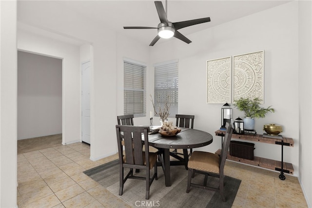 dining area with tile patterned floors and ceiling fan