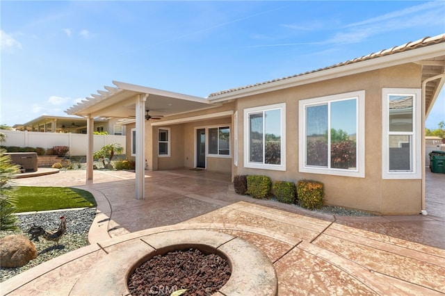 back of property featuring a patio area, stucco siding, fence, and a ceiling fan
