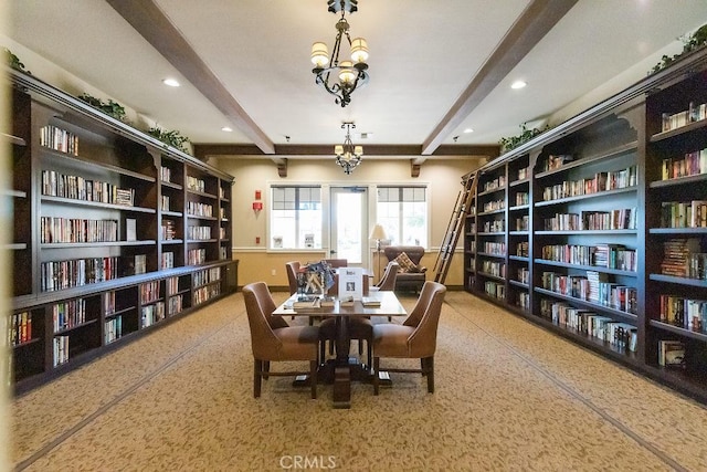 living area featuring wall of books, beamed ceiling, and recessed lighting