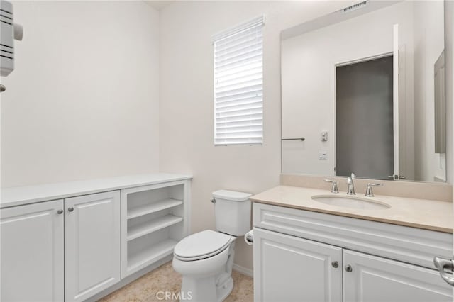 bathroom with vanity, visible vents, baseboards, and toilet