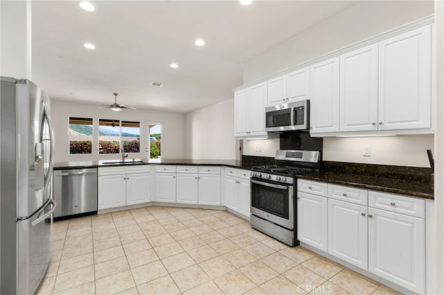 kitchen with recessed lighting, a peninsula, white cabinetry, a ceiling fan, and stainless steel appliances