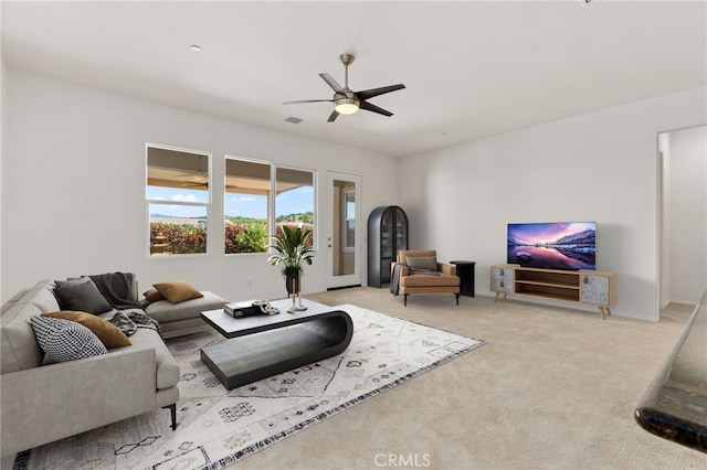 carpeted living room featuring visible vents and a ceiling fan