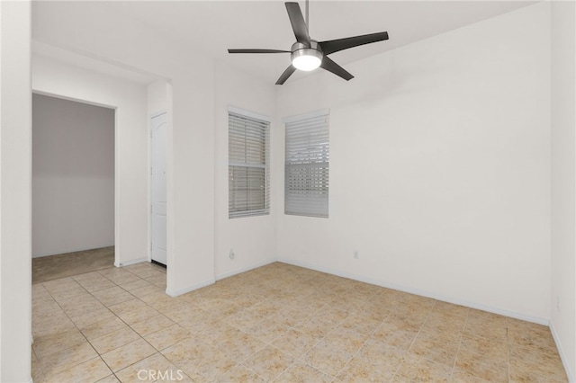 spare room with baseboards, a ceiling fan, and tile patterned flooring