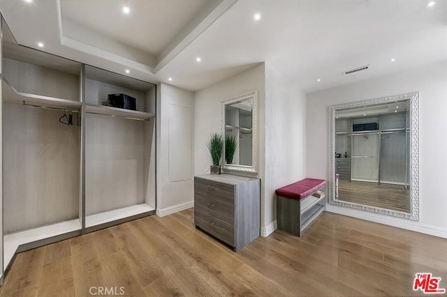 interior space featuring visible vents, baseboards, recessed lighting, and wood finished floors