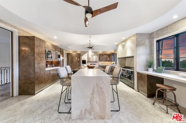 dining space with a ceiling fan and recessed lighting