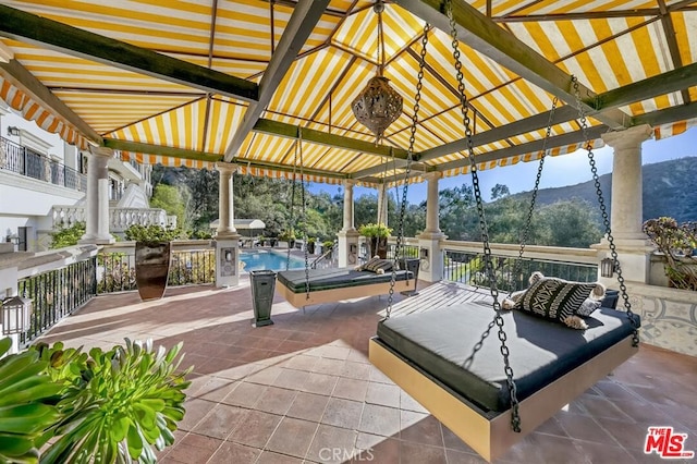 view of patio / terrace featuring a fenced in pool, a gazebo, and a mountain view