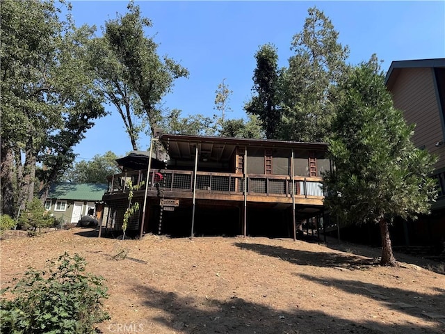 rear view of house with a wooden deck