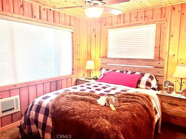 bedroom with wood walls, wood ceiling, a ceiling fan, and heating unit