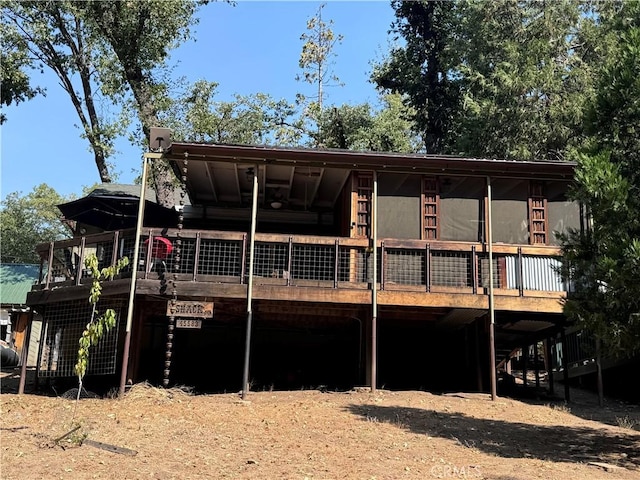 back of house featuring a wooden deck