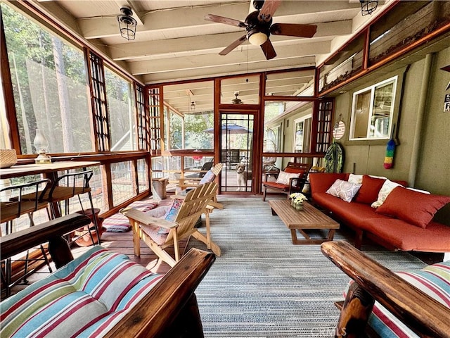 sunroom / solarium with beamed ceiling, ceiling fan, and an outdoor living space