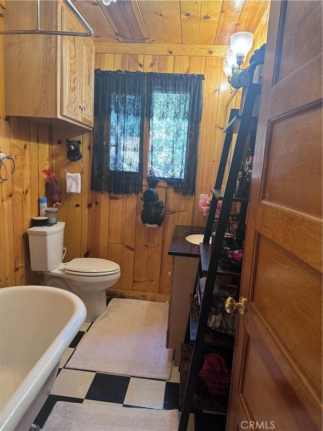 bathroom with wood walls, toilet, wooden ceiling, and a soaking tub