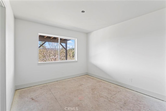empty room featuring baseboards