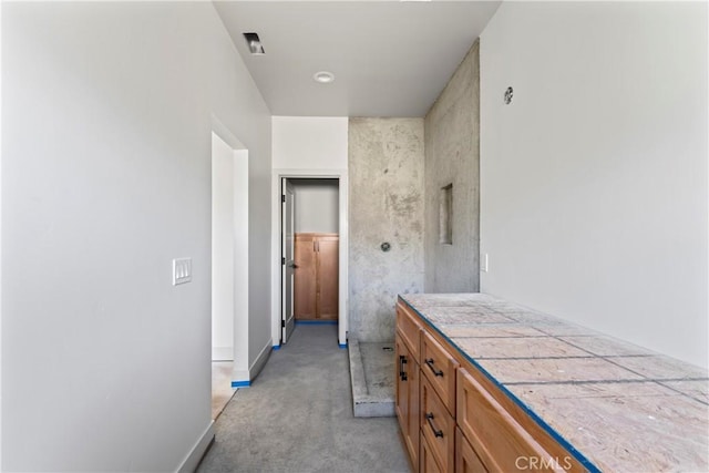 corridor with light carpet and baseboards